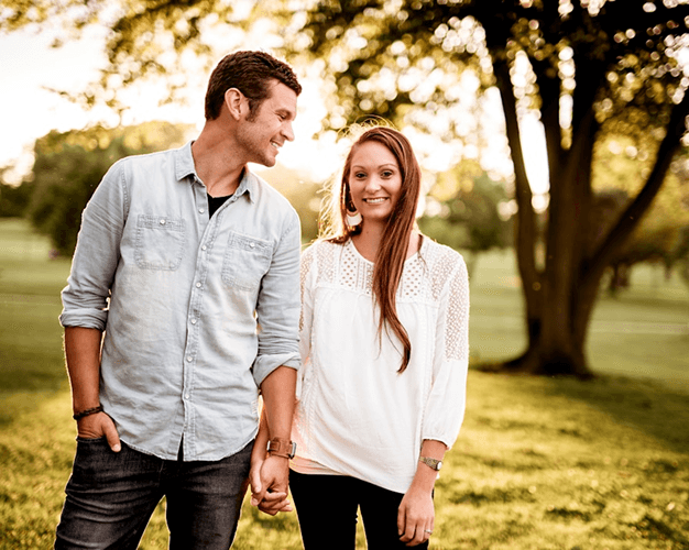 Two people laughing together outdoors